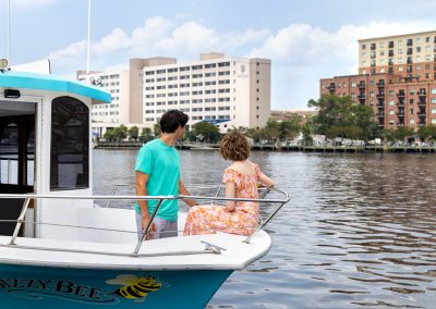 couple on boat overlooking hotel